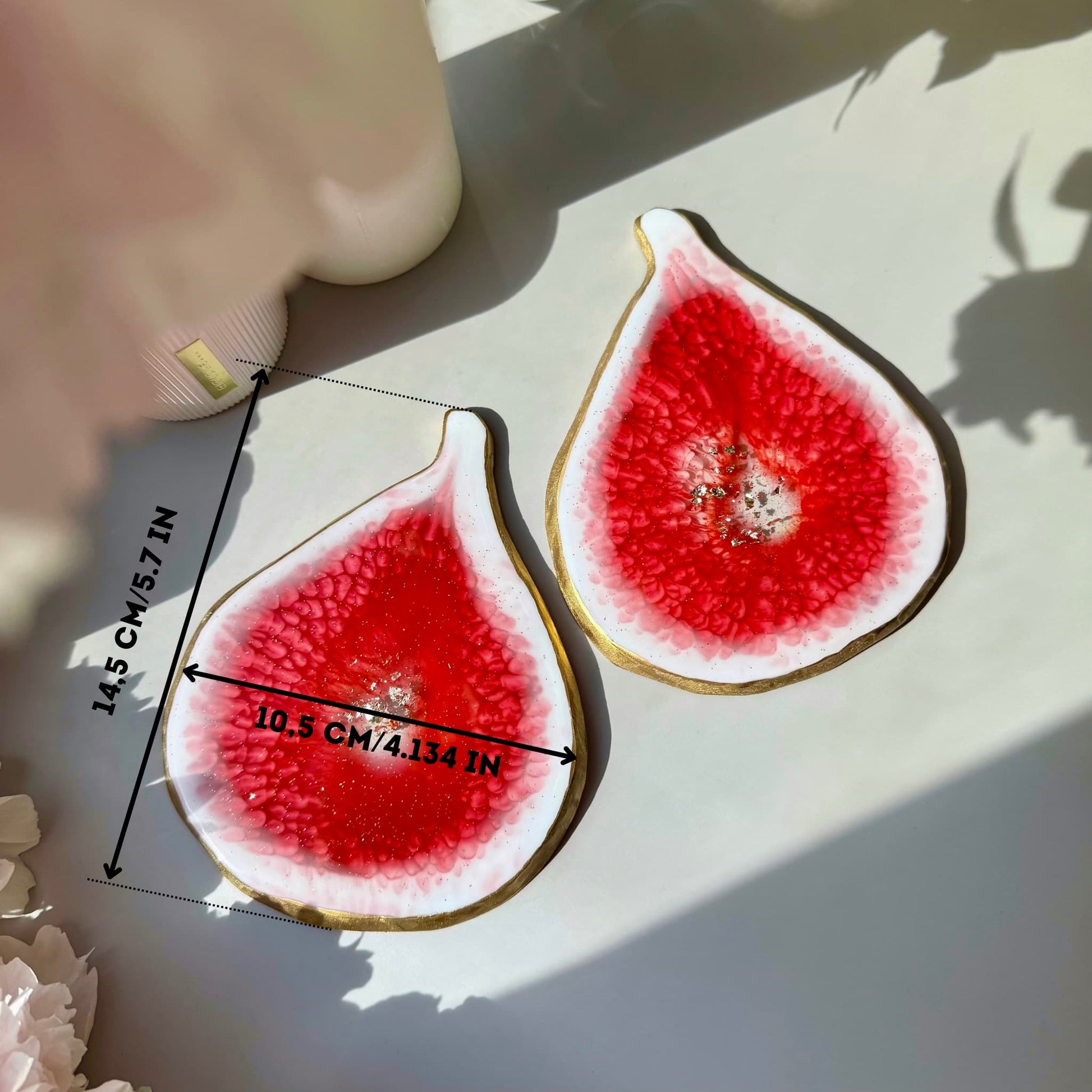 Decorative handmade coasters shaped like sliced figs with measurements on a light background