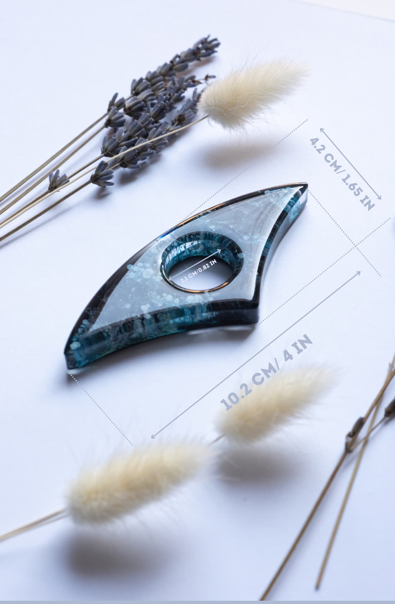 Handmade blue page holder on a white surface with dried lavender and grasses.