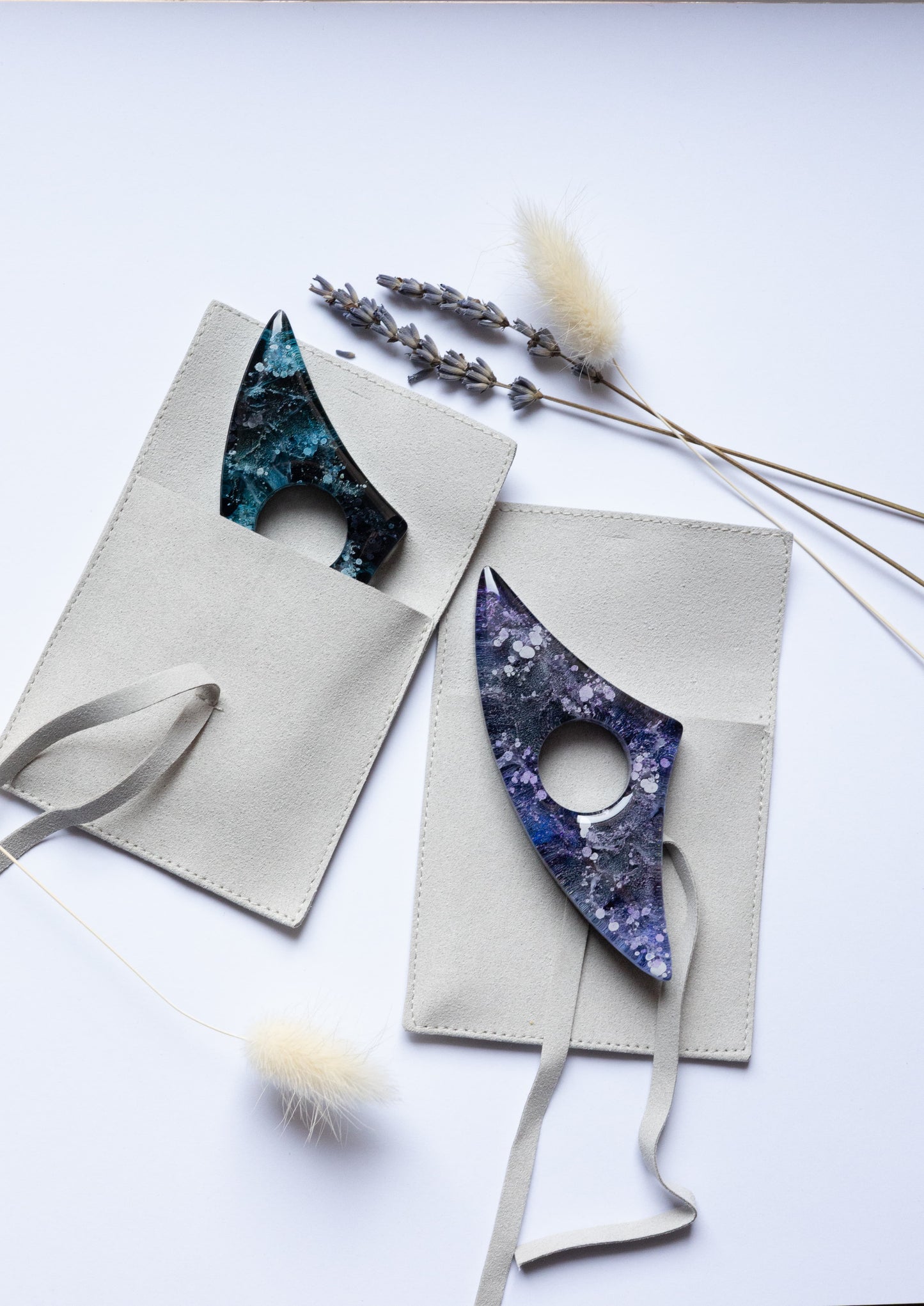 Handmade page holders in gift bags against a white background