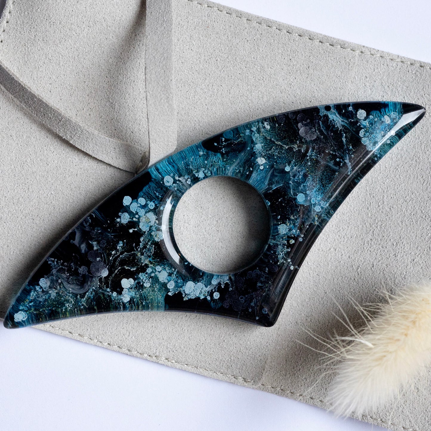 Handmade Page Holder with blue and black marbled design on a beige surface
