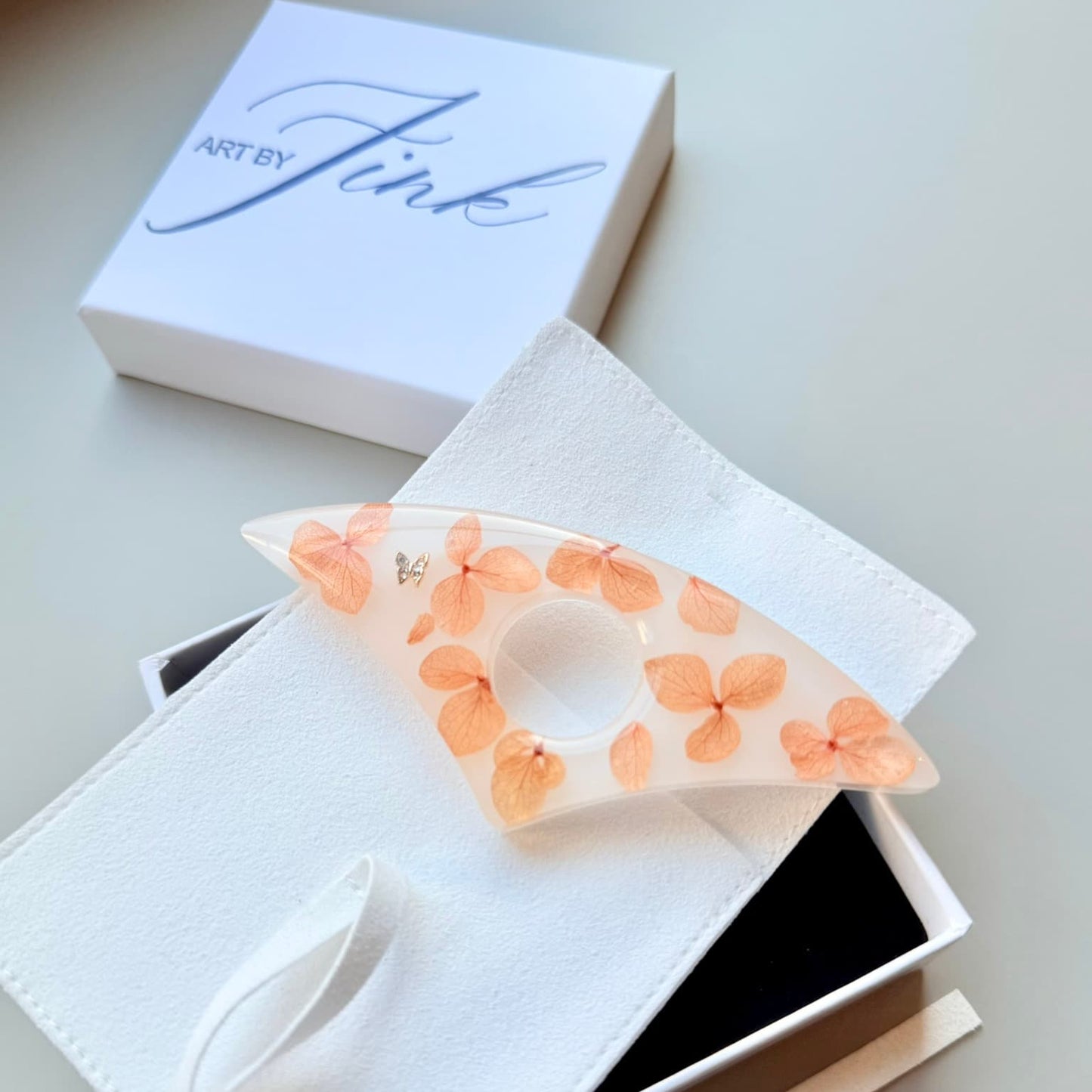 Handmade Page Holder with floral design in a white box, branded 'ArtByFink'.