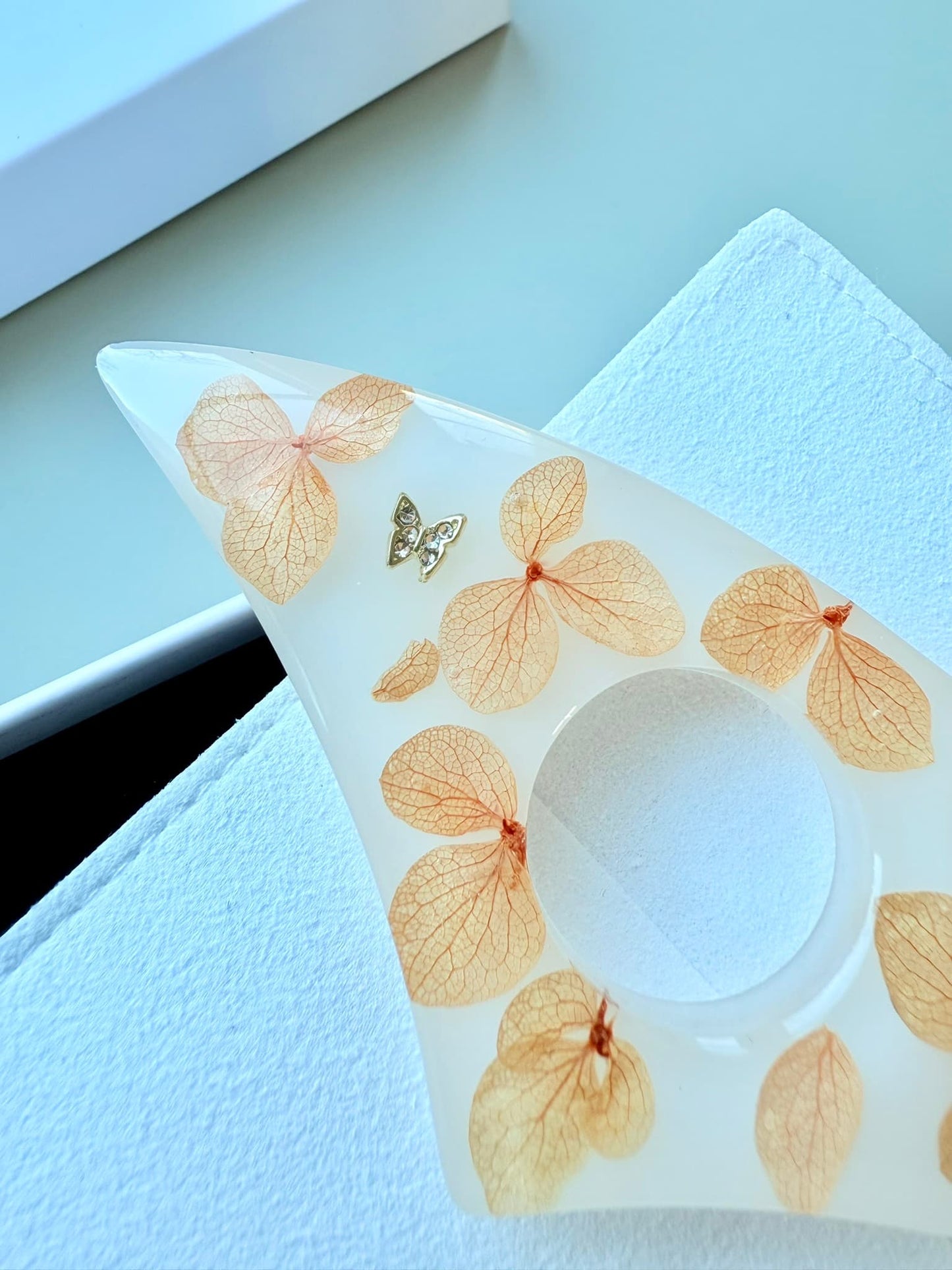 Handmade Page Holder with butterfly and leaf patterns on a white surface