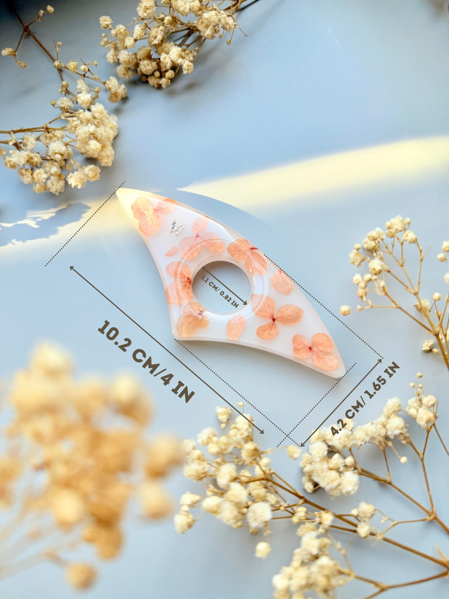 Handmade Page Holder with floral design on a light blue background with dried flowers