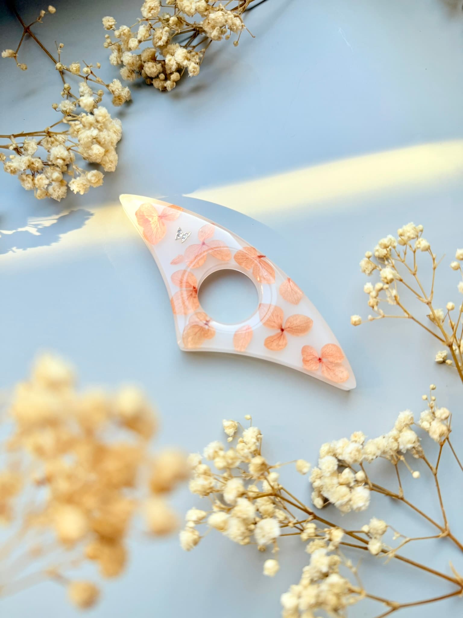 Handmade Page Holder with Real Flowers on a light blue background with dried flowers.