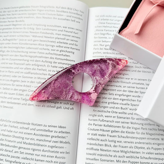 Pink Handmade page holder on an open book