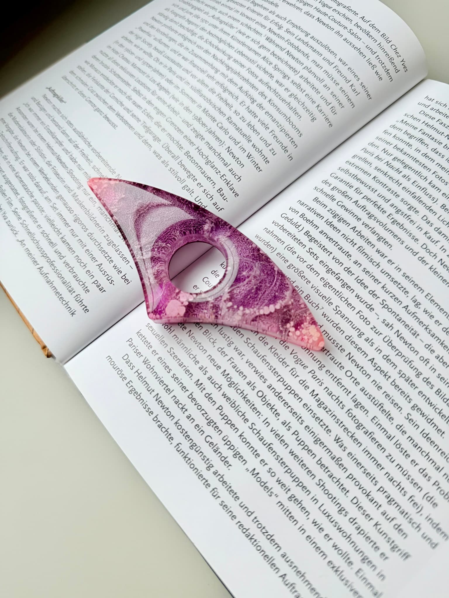 Pink and purple handmade page holder on an open book
