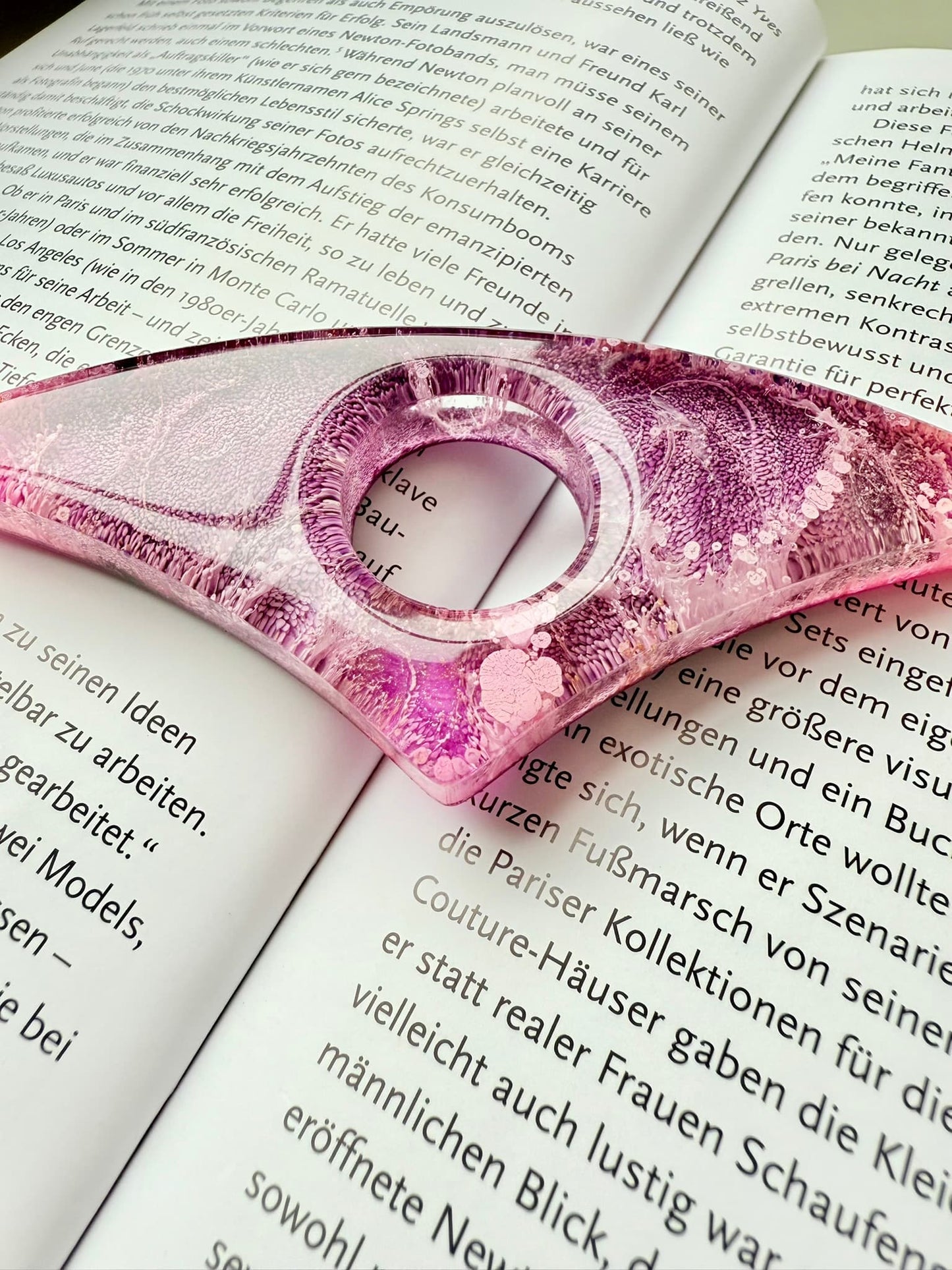 Pink handmade page holder on an open book