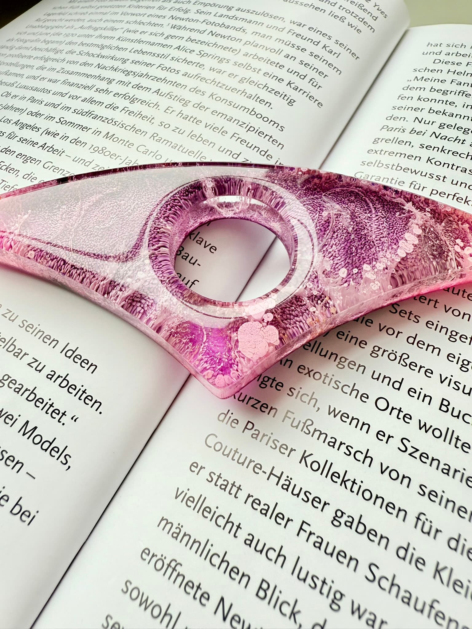 Pink handmade page holder on an open book