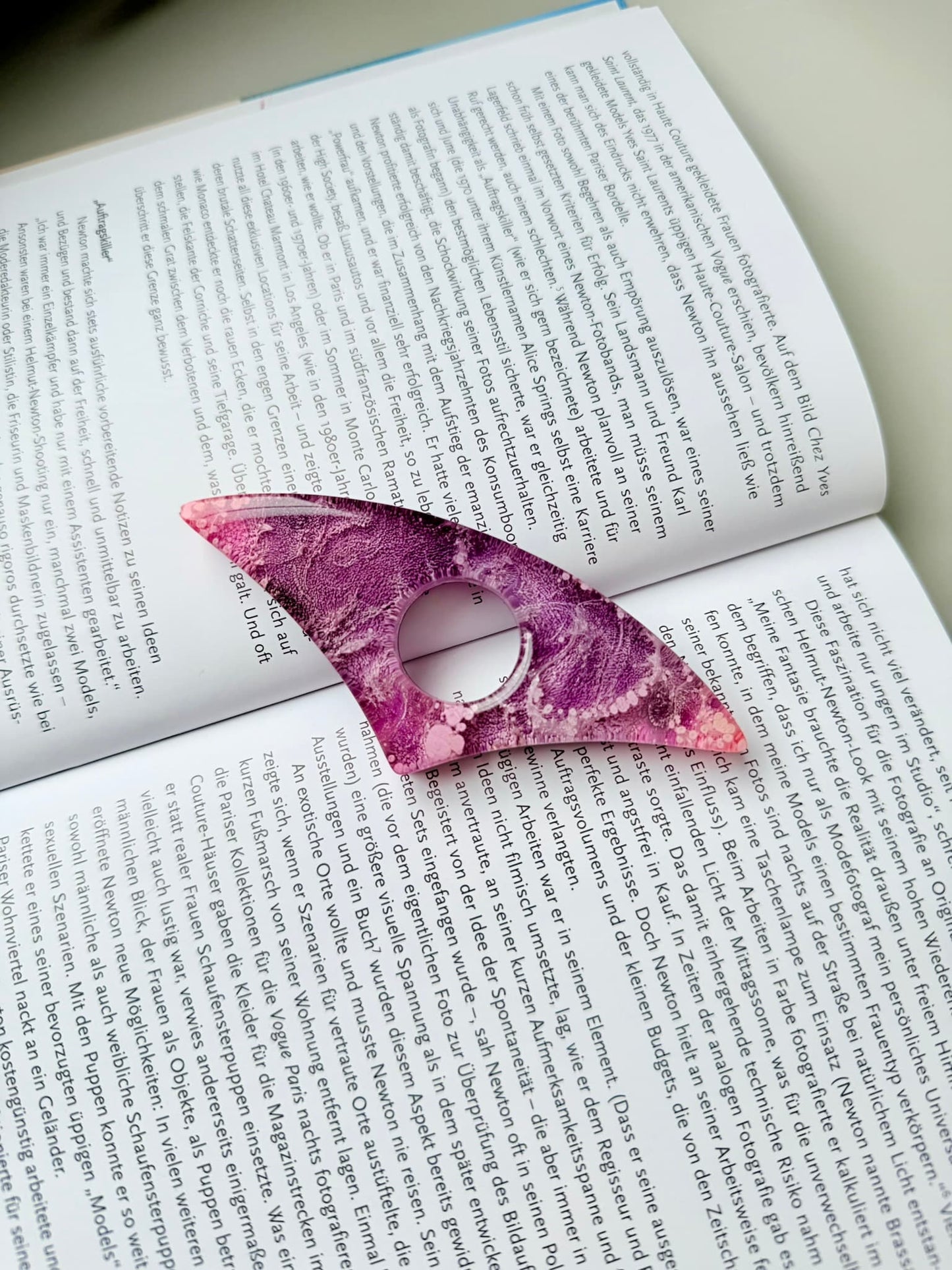 Pink handmade page holder on an open book